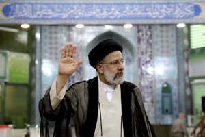 Ebrahim Raisi, a candidate in Iran's presidential elections waves to the media after casting his vote at a polling station in Tehran, Iran Friday, June 18, 2021