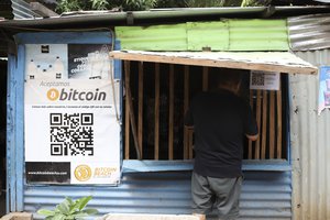 A worker at Hope House, an organization that sponsors the use of cryptocurrencies in El Zonte beach, makes a purchase at a small store that accepts Bitcoin, in Tamanique, El Salvador, Wednesday, June 9, 2021