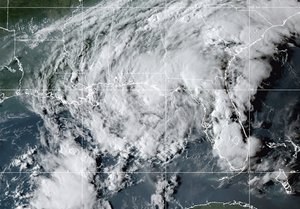 This GOES- East GeoColor satellite image taken Wednesday, Sept. 8, 2021, at 10:30 p.m. EDT., and provided by NOAA, shows Tropical Storm Mindy as it makes landfall on the Florida Panhandle