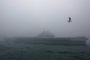 The Chinese People's Liberation Army (PLA) Navy aircraft carrier Liaoning participates in a naval parade to commemorate the 70th anniversary of the founding of China's PLA Navy