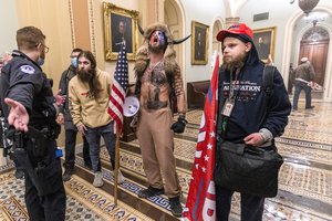 In this Wednesday, Jan. 6, 2021, file photo, supporters of President Donald Trump, including Jacob Chansley, center with fur hat, are seen during the riot at the U.S. Capitol in Washington.