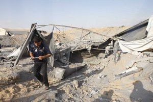 Palestinian clears the wreckage from a damaged smuggling tunnel targeted in an overnight Israeli air strike in Rafah, in the southern Gaza Strip, August 2, 2011. An Israeli army spokesperson said the strike was carried out in response to a rocket fired from Gaza into southern Israel on Monday night, moderately injuring one Israeli woman. ( Photo By Ahmed Deeb/WN)