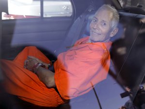 FILE - In March 17, 2015, file photo, New York real estate heir Robert Durst smiles as he is transported from Orleans Parish Criminal District Court to the Orleans Parish Prison after his arraignment on murder charges in New Orleans.