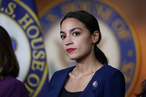 In this June 16, 2021, file photo Rep. Alexandria Ocasio-Cortez, D-N.Y., listens as House Speaker Nancy Pelosi, D-Calif., speaks during a news conference at the Capitol in Washington.