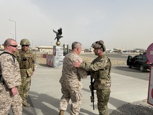 U.S. Marine Corps Gen. Frank McKenzie, the commander of U.S. Central Command, meets with U.S. Navy Rear Adm. Peter Vasely, commander of U.S. Forces Afghanistan-Forward, at Hamid Karzai International Airport, Afghanistan on August 17, 2021