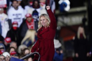 Rep. Marjorie Taylor Greene, R-Ga., gestures as President Donald Trump speaks at a campaign rally in support of Senate candidates Sen. Kelly Loeffler, R-Ga., and David Perdue in Dalton, Ga., Monday, Jan. 4, 2021