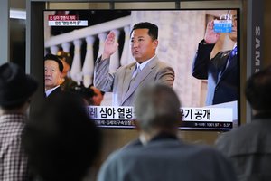 File - People watch a TV showing North Korean leader Kim Jong Un during a military parade in Pyongyang, North Korea, at Seoul Railway Station in Seoul, South Korea, Thursday, Sept. 9, 2021.