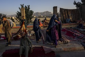 In this Wednesday, Sept. 15, 2021, file photo, Afghan women walk through a second-hand market where many families sold their belongings before leaving the country or due to financial struggle, in Kabul, Afghanistan.