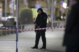 A Russian police officer secures the area near the building of the Federal Security Service (FSB, Soviet KGB successor) in the background in Moscow, Russia, Thursday, Dec. 19, 2019