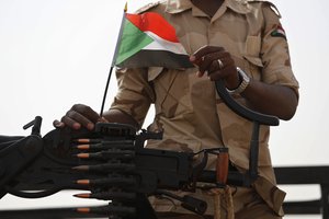 File - In this June 22, 2019 file photo, a Sudanese soldier from the Rapid Support Forces or RSF, led by Gen. Mohammed Hamdan Dagalo, stands on his vehicle during a military-backed tribe's rally, in the East Nile province, Sudan.