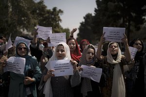 Afghan women march to demand their rights under the Taliban rule during a demonstration near the former Women's Affairs Ministry building in Kabul, Afghanistan, Sunday, Sept. 19, 2021. The interim mayor of Afghanistan’s capital said Sunday that many female city employees have been ordered to stay home by the country’s new Taliban rulers.