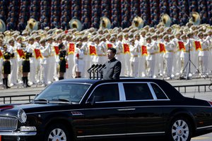 File - Chinese President Xi Jinping stands in a car to review the army during a parade commemorating the 70th anniversary of Japan's surrender during World War II held in front of Tiananmen Gate in Beijing, Thursday, Sept. 3, 2015.