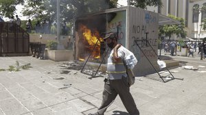 A Chivo digital wallet ATM, which exchanges cash for Bitcoin cryptocurrency, burns after being torched during a protest against President Nayib Bukele in San Salvador, El Salvador, Wednesday, Sept. 15, 2021.