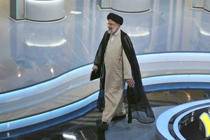 In this Saturday, June 12, 2021 file photo made available by Young Journalists Club, YJC, presidential candidate Ebrahim Raisi leaves a final debate of candidates, at a state-run TV studio in Tehran, Iran