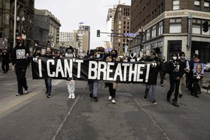 File - A silent march for justice for George Floyd in downtown Minneapolis, Minnesota, on the day before Derek Chauvin trial is scheduled to begin, 7 March, 2021.