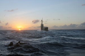 SEALs and divers from SEAL Delivery Vehicle Team (SDVT) 1 swim back to the guided-missile submarine USS Michigan (SSGN 727).