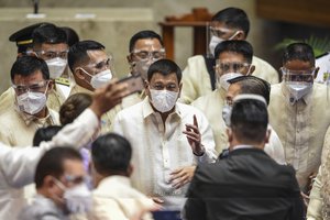 Philippine President Rodrigo Duterte is surrounded by security after he delivered his final State of the Nation Address at the House of Representatives in Quezon city, Philippines on Monday, July 26, 2021