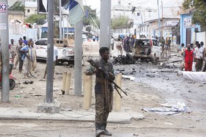 A Somali soldier secures the area after a car bomb attack at a Presidential Palace checkpoint in Mogadishu, Somalia, Saturday Sept. 25, 2021.