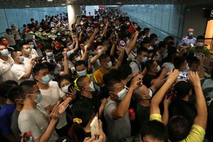 Supporters of Huawei CFO Meng Wanzhou gather at Shenzhen Bao’an International Airport in Shenzhen in southern China’s Guangdong Province, Saturday, Sept. 25, 2021.