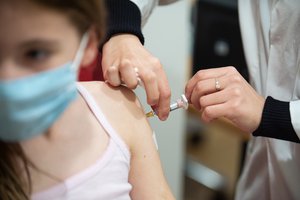 A child who has just been vaccinated against influenza at Air France's international vaccination centre