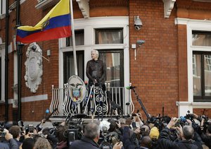 In this file photo dated Friday May 19, 2017, watched by the media WikiLeaks founder Julian Assange looks out from the balcony of the Ecuadorian embassy prior to speaking, in London. Judge Vanessa Baraitser has ruled that Julian Assange cannot be extradited to the US.