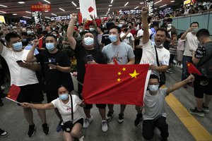 Supporters of Huawei CFO Meng Wanzhou gather at Shenzhen Bao'an International Airport in Shenzhen in southern China's Guangdong Province, Saturday, Sept. 25, 2021