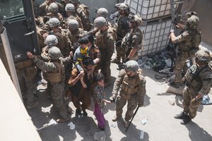 In this Aug. 20, 2021, file photo provided by the U.S. Marine Corps, U.S. Marines and Norweigian coalition forces assist with security at an Evacuation Control Checkpoint ensuring evacuees are processed safely during an evacuation at Hamid Karzai International Airport in Kabul, Afghanistan