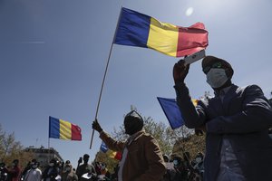 Chadian leaving in France stage a protest with their national flags in Paris, Sunday, April 25, 2021.