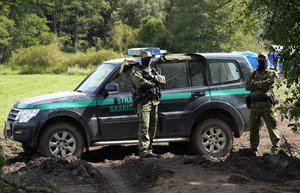 Polish border guards block an area the border with Belarus in Usnarz Gorny, Poland, on Wednesday, Sept. 1, 2021