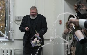 Colleagues pour champagne on Novaya Gazeta editor Dmitry Muratov at the Novaya Gazeta newspaper, in Moscow, Russia, Friday, Oct. 8, 2021.