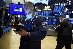 Trader John Panin, left, works on the floor of the New York Stock Exchange, Tuesday, Aug. 10, 2021