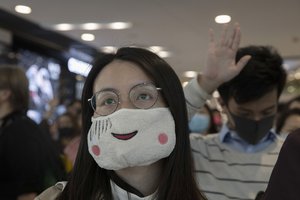 Hongkongers hold up their hands to represent their five demands and chant "Pass the bill, save Hong Kong" at the IFC mall in Hong Kong on Thursday, Nov. 21, 2019.