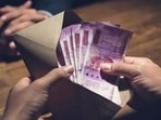 Businessman counting money, Indian Rupee currency, in the envelope just given by his partner after making an agreement in private dark room - loan, briberry and corruption scam concepts (Getty Images/iStockphoto)