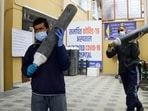 Health workers carrying oxygen cylinders from a store in a hospital in Shimla. (Deepak Sansta/HT File Photo)