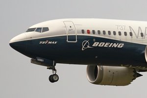 FILE- In this Sept. 30, 2020, file photo, a Boeing 737 Max jet, piloted by Federal Aviation Administration (FAA) chief Steve Dickson, prepares to land at Boeing Field following a test flight in Seattle.