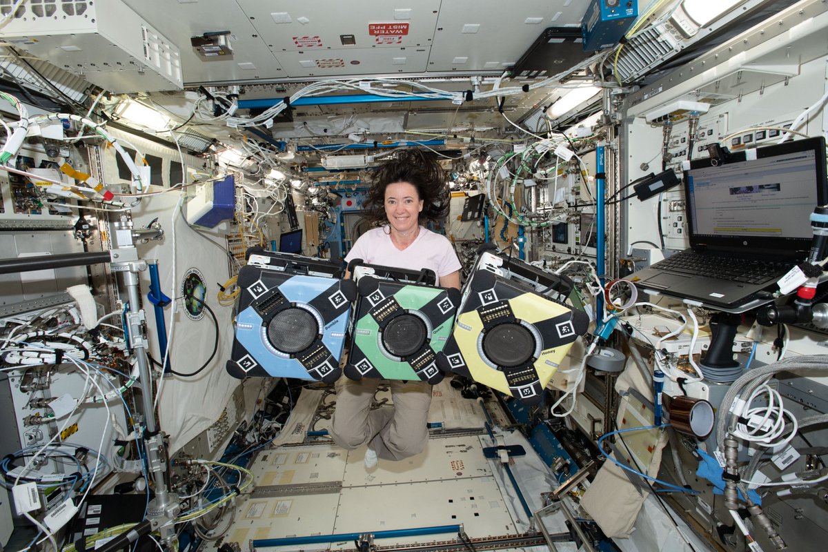 NASA astronaut Megan McArthur poses with the Astrobee robotic free-flyers in support of the Kibo Robot Programming Challenge (Robo-Pro Challenge). The Kibo-RPC, allows students to create programs to control Astrobee, a free-flying robot aboard the International Space Station (ISS).