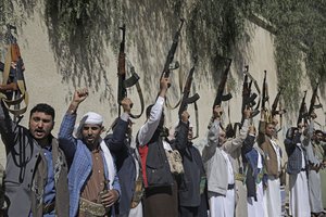 File - Tribesmen loyal to the Houthi rebels chant slogans as they hold their weapons during a gathering aimed at mobilizing more fighters for the Houthi movement in Sanaa, Yemen, Tuesday, Feb. 25, 2020.