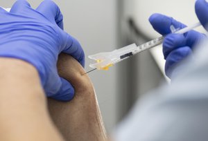 A medical worker fills a syringe with a dose of the Pfizer-BioNTech Covid-19 disease vaccine at the corona vaccination centre at the Robert Bosch hospital in Stuttgart, Germany