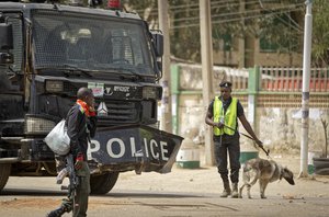 Security forces and an anti-riot truck guard the offices of the electoral commission in Kano, northern Nigeria Monday, Feb. 25, 2019.