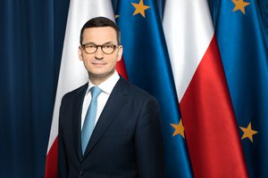 Mateusz Morawiecki as President of the Polish Council of Ministers in front of the Polish flags and the flags of the European Union