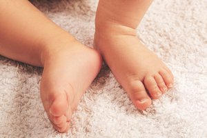 Small feet of a sleeping baby boy, close-up