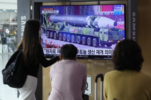 People watch a TV screen showing a file image of a North Korean missile on a military parade during a news program at the Seoul Railway Station in Seoul, South Korea, Monday, Aug. 30, 2021