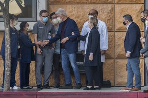 Former President Bill Clinton, and former first lady and former U.S. Secretary of State Hillary Clinton thank members of the medical staff as he is released from the University of California Irvine Medical Center in Orange, Calif., Sunday, Oct. 17, 2021.