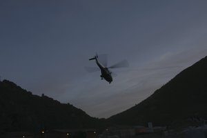 French President Emmanuel Macron leaves Breil-sur-Roya, southeastern France, in an helicopter Wednesday, Oct.7, 2020.