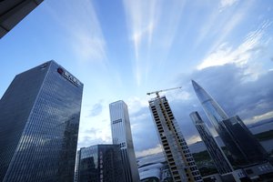 The Evergrande headquarters, left, stands in Shenzhen, China, Friday, Sept. 24, 2021.