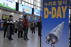 People watch a TV broadcasting the launch of the Nuri rocket, at Seoul Railway Station in Seoul, South Korea, Thursday, Oct. 21, 2021. South Korea test launched its first domestically produced space rocket on Thursday in what officials