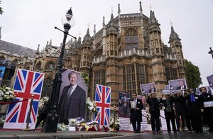 FILE - In this Oct. 18, 2021 file photo, members of the Anglo-Iranian communities and supporters of the National Council of Resistance of Iran hold a memorial service for British member of Parliament David Amess outside the Houses of Parliament in London.