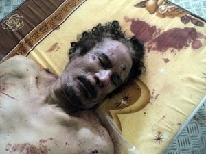 The body of Libyan dictator Moammar Gadhafi lies on a mattress in a commercial freezer at a shopping center Misrata, Libya, Friday, Oct. 21, 2011