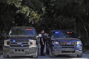 North Port, Fla., police officers block the entrance to the Myakkahatchee Creek Environmental Park Wednesday, Oct. 20, 2021, in North Port