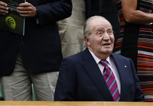 Former Spanish King Juan Carlos takes his seat for the Women's Singles final match